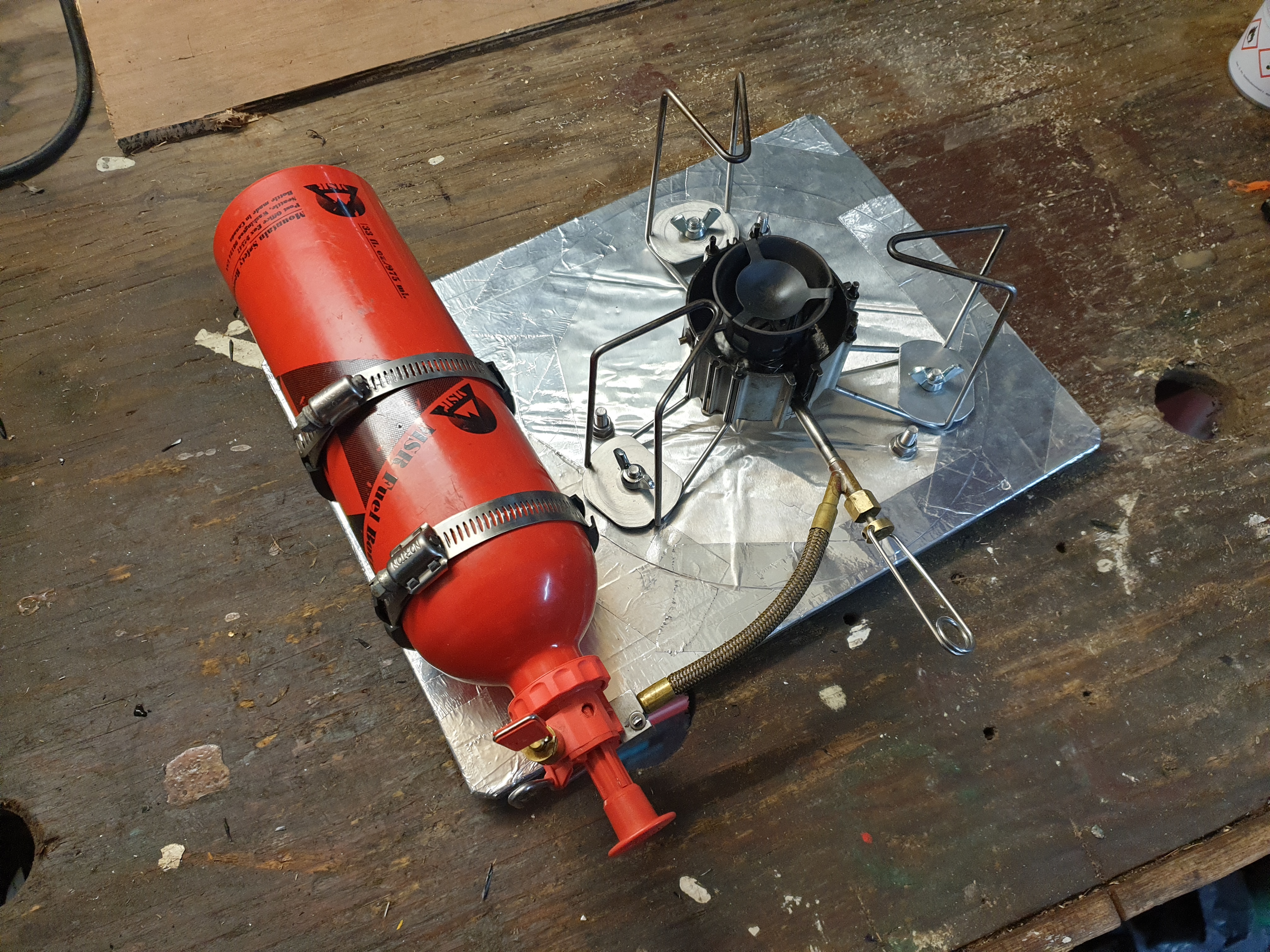 MSR Dragonfly and fuel bottle mounted onto the stove board